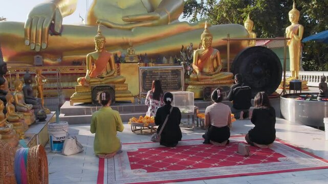 People praying at the Big Buddha statue  on Khao Phra Tamnak (Pattaya hill) in Pattaya, Thailand	
