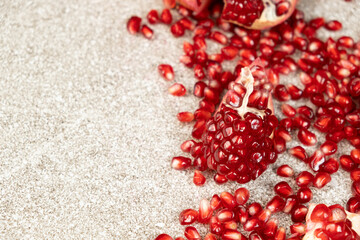 Pomegranate Seeds and Pomegranates on a Stone Gray Background Place for Text.