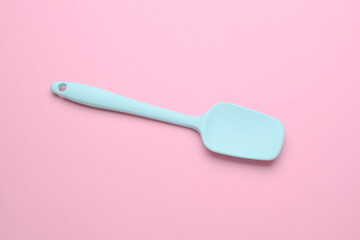 Silicone kitchen spatula on a pink background