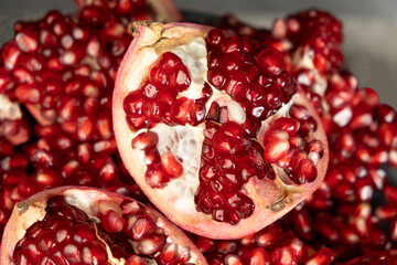 Pomegranate background, lots of peeled pomegranates and seeds