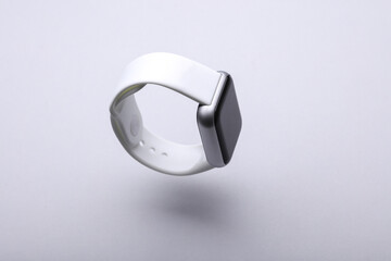 Modern smart watch floating on gray background