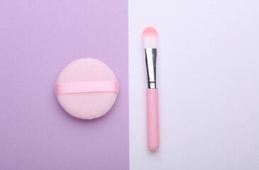 Pink Makeup brush and sponge on purple white background