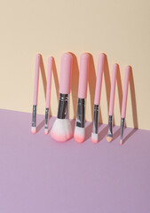 Makeup brushes on pastel background. Creative layout. Beauty concept