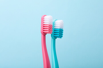 Plastic toothbrushes on blue background close up