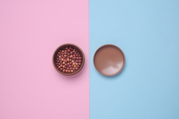 Makeup powder balls on blue pink background
