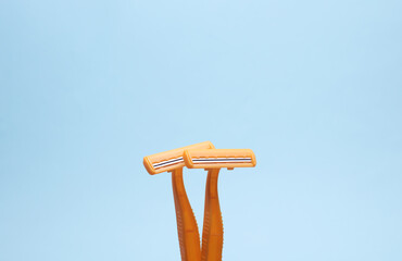 disposable plastic razors on blue background