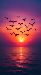 Obraz premium Flock of Birds Migrating Across a Vibrant Spring Sunset Sky over a Calm Ocean, Capturing the Essence of Seasonal Change and Freedom 