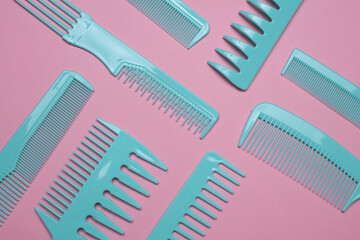 Set of blue plastic combs on pink background.