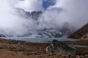 Amazing mountain panorama of turquoise lake and buildings of Gokio settlement from peak Gokyo Ri. It is famous region of Himalayas, Nepal