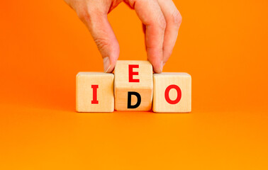 Initial exchange or DEX offering symbol. Concept words abbreviation IEO or IDO on wooden block....