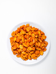 Balado peeled peas served on a white plate, isolated on a white background. Perfect for a snack.