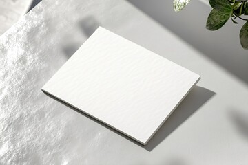 mockup of blank business card with embossed edges placed on clean gray surface