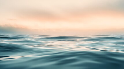 Obraz premium Serene ocean waves reflecting the soft colors of dawn, creating a peaceful and tranquil scene at sunrise.