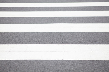 Fototapeta premium Crosswalk white stripes on asphalt road background texture