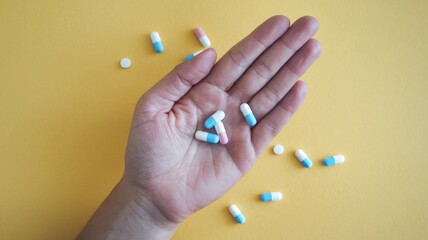 Hand and medicine pills, health and health care concept.