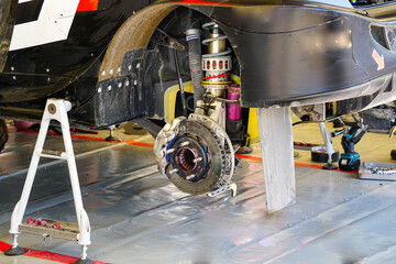 Rally car rear wheel high performance suspension and brake disc with caliper