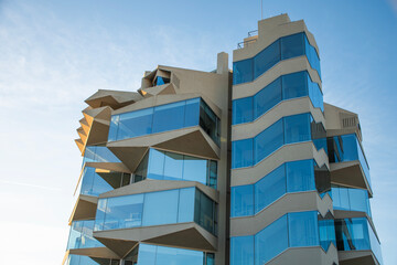 modern building with contemporary architecture and facade cut out in the rising sun in glass windows