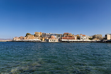 Chania, old Venetian harbor with Hasan Pasha Mosque and row of shops with cafes on Crete, Greece