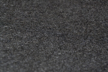 Black wool fabric: A detailed view of black wool material with a smooth, even texture. Black wool texture: The rich black tone highlights the fabric's versatility and timelessness.