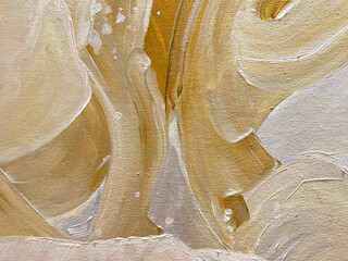 Close up of random brushed paint in gold and white color with random strokes and wavy pattern. random seamless background texture