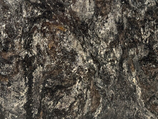 Close up of black silver natural granite in random stone pattern. Seamless background texture. 