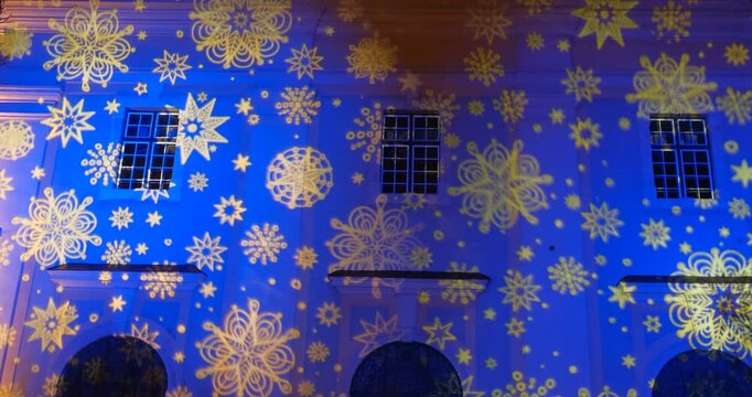 Christmas video projection on old building wall at night