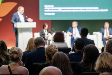 Business conference featuring panel discussion with professionals and audience interaction at...