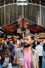 Tourist enjoying a refreshing drink at la boqueria market in barcelona