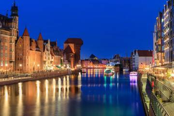 Fototapeta premium Main city in Gdansk with historic Port Crane over Motlawa river at night, Poland