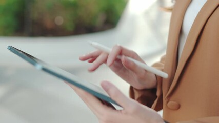 Happy Asian Businesswoman Planning in an Outdoor Workspace. Hybrid Work in Urban Greenery, Smiling Business woman Using Tablet. Joyful Manager Writing Emails in a Park., Remote Work Lifestyle - Powered by Adobe