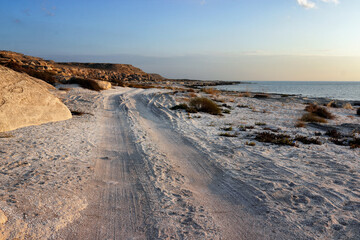 Shell coast of the Caspian Sea. Road along the sea.