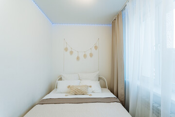 This beautifully designed bedroom features a cozy bed, elegant curtains, and a large window,...