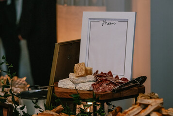 view of a table top with an empty white frame with the menu during an event