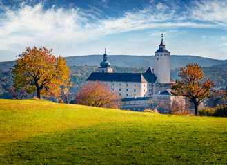 Marvelous autumn view of Forchtenstein Castle, Austria. Wonderful morning scene of apple garden in...