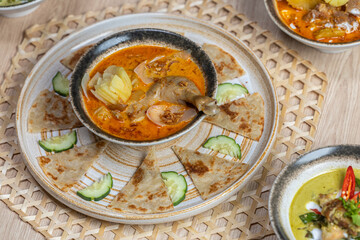 Massaman curry with roti. Massaman Curry with Chicken or Beef and Potatoes. Thai Massaman curry with chicken or beef halal food