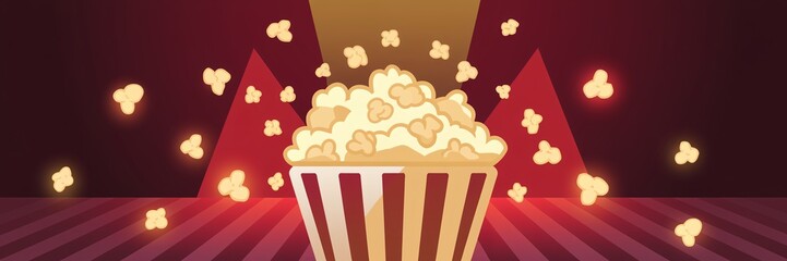 Popcorn in striped bucket on stage.
