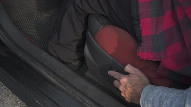 A man turns on the heated driver's seat