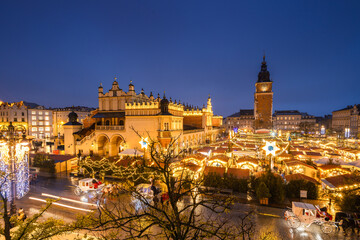 View of the Krakow Christmas Market 2024 and the historic Old Town Square, beautifully illuminated with festive lights and vibrant holiday atmosphere.