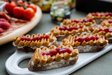 A white plate beautifully arranged and topped with delicious peanut butter and jelly sandwiches, offering a delightful treat thats perfect for any casual meal or snack time