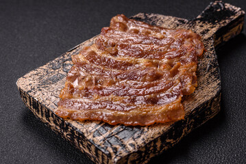 Crispy fried pork bacon sliced with salt, spices and herbs