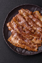 Crispy fried pork bacon sliced with salt, spices and herbs
