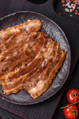 Crispy fried pork bacon sliced with salt, spices and herbs