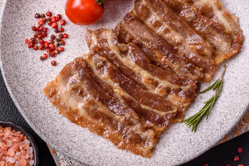 Crispy fried pork bacon sliced with salt, spices and herbs