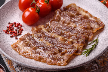 Crispy fried pork bacon sliced with salt, spices and herbs