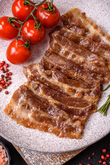 Crispy fried pork bacon sliced with salt, spices and herbs