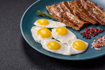 A hearty, delicious breakfast with fried eggs, bacon and tomatoes