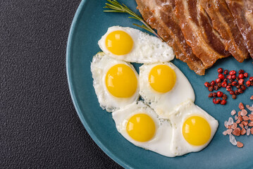 A hearty, delicious breakfast with fried eggs, bacon and tomatoes