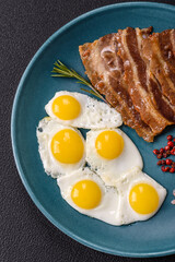 A hearty, delicious breakfast with fried eggs, bacon and tomatoes