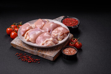 Fresh raw chicken thigh fillets with salt, spices and herbs