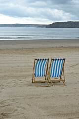 Two empty loungers on the beach.